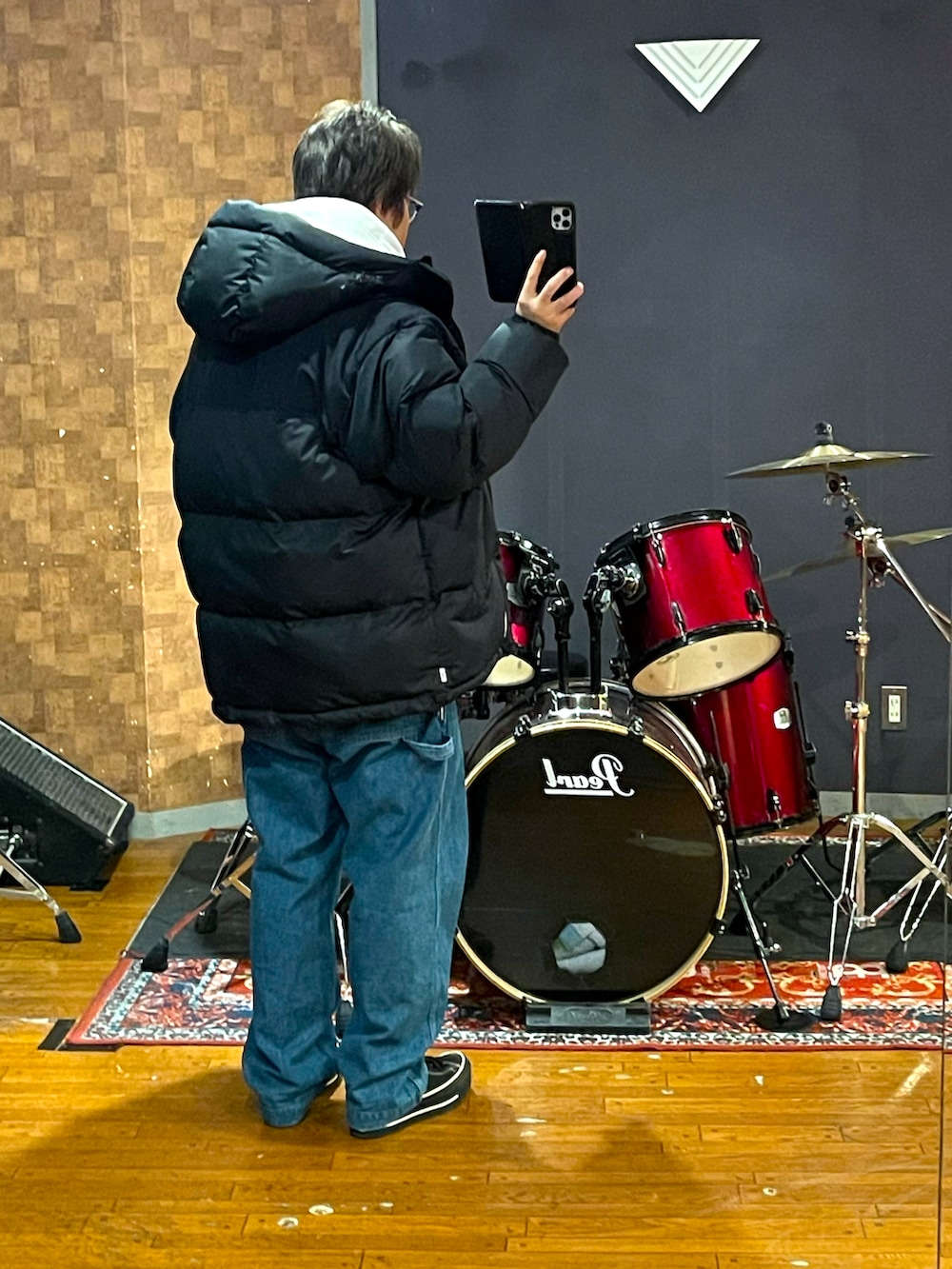 ブラック系のダウンジャケット/コート、ブルー系のデニムパンツ、ブラック系のスニーカーを着用したメンズの冬コーディネートの4枚目の写真