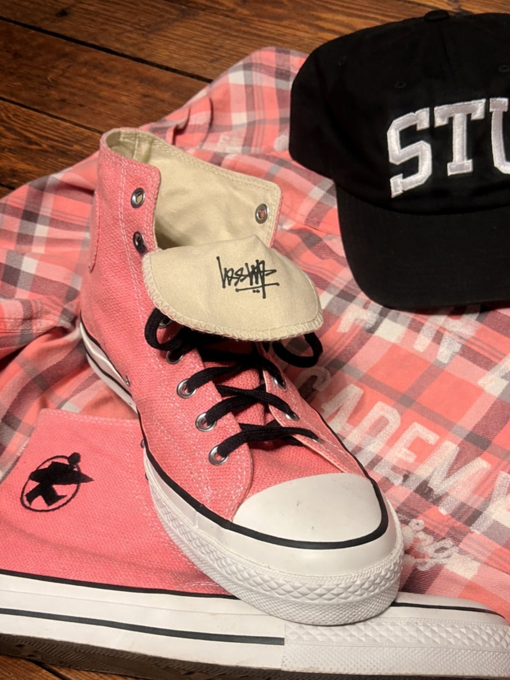 ブルー系のデニムパンツ、ピンク系のスニーカー、ブラック系のキャップを着用したメンズの春コーディネートの3枚目の写真