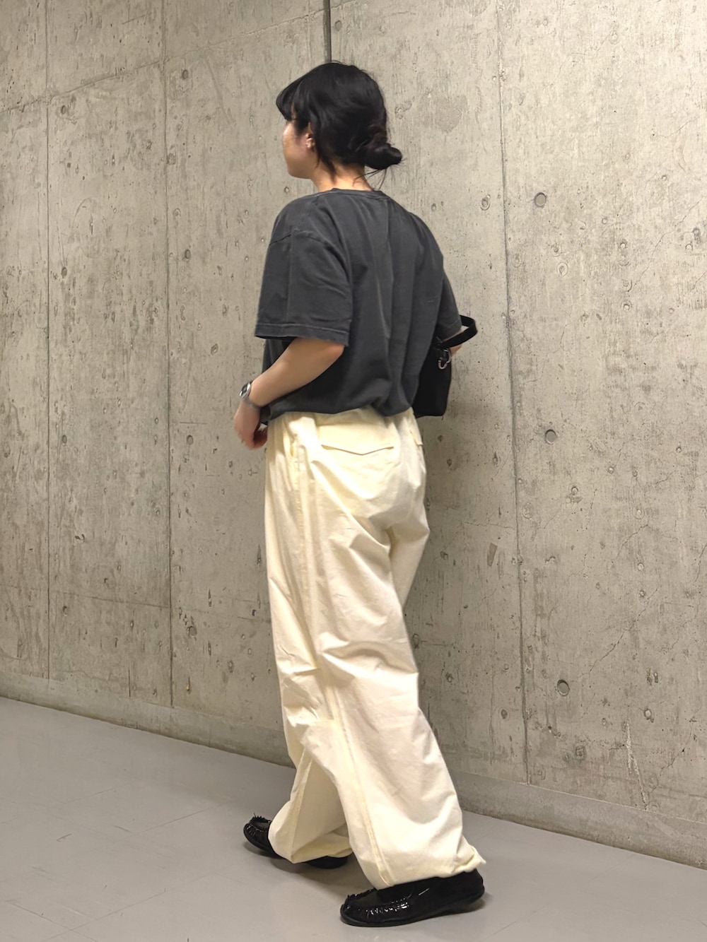 グレー系のTシャツ/カットソー、ホワイト系のその他パンツ、ブラック系のトートバッグを着用したレディースの春コーディネートの2枚目の写真