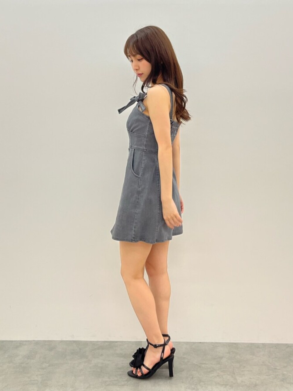 ブラック系のサンダル、ブラック系のワンピースを着用したレディースの春コーディネートの2枚目の写真