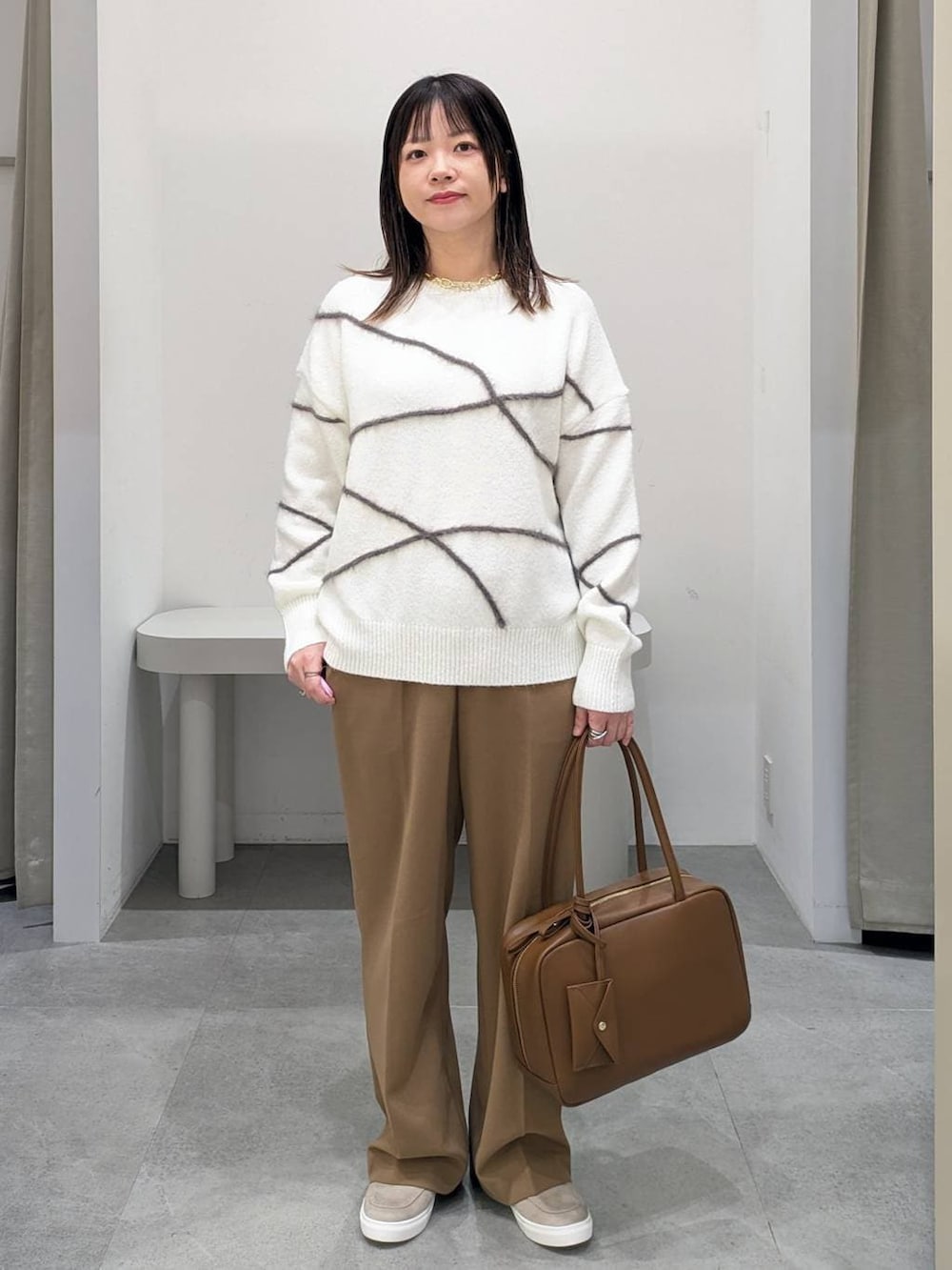 イエロー系のその他パンツ、イエロー系のボストンバッグ、ベージュ系のローファーを着用したレディースの冬コーディネートの2枚目の写真