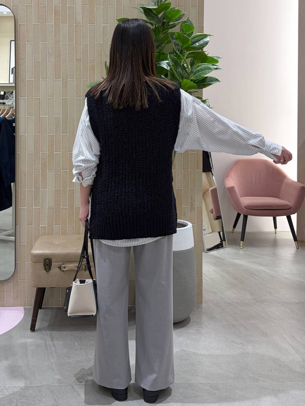 ブラック系のパンプス、ブラック系のトートバッグ、ホワイト系のシャツ/ブラウスを着用したレディースの春コーディネートの4枚目の写真