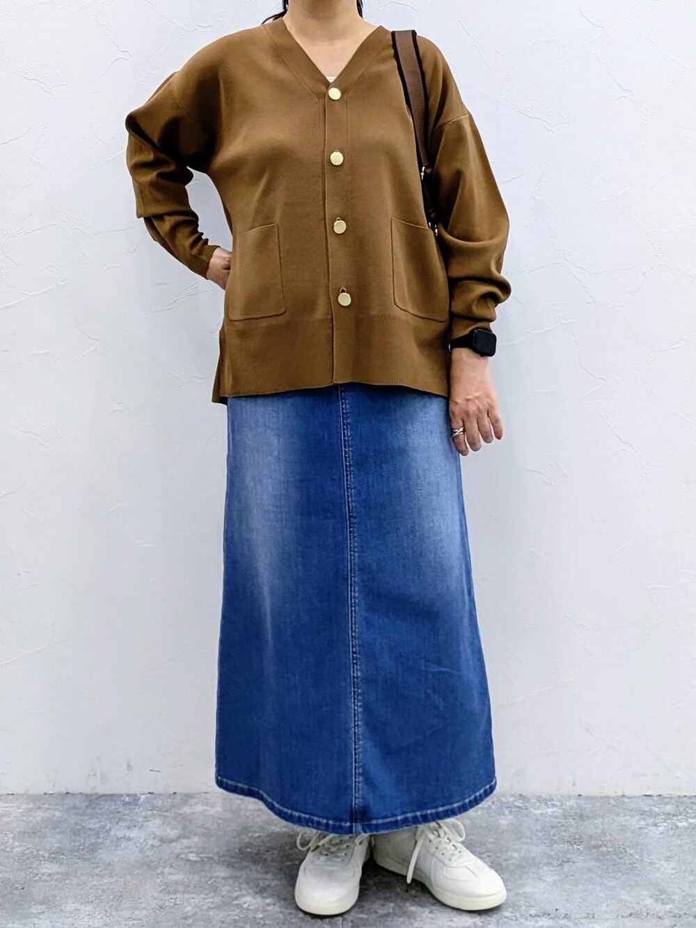 ブラウン系のカーディガン/ボレロ、ブルー系のデニムスカートを着用したレディースの夏コーディネートの6枚目の写真