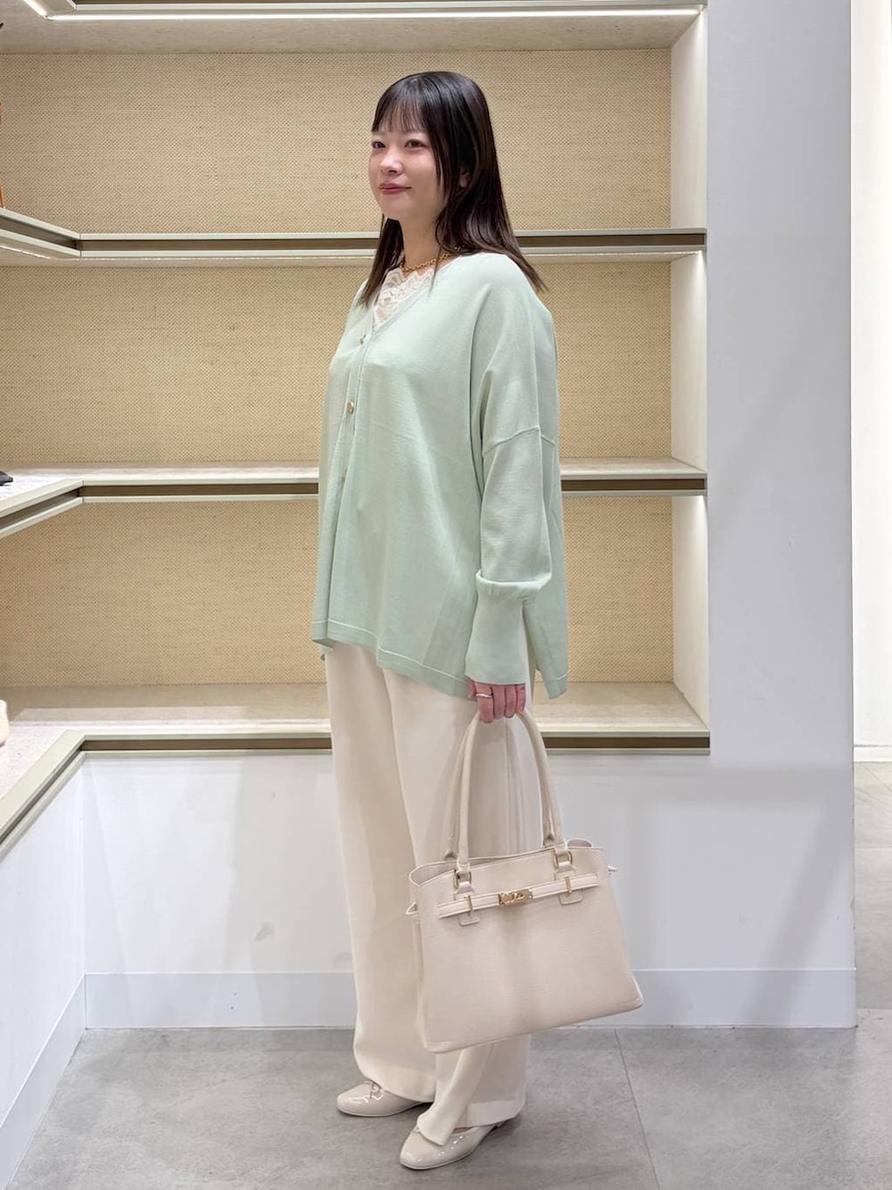 ホワイト系のその他パンツ、ホワイト系のタンクトップ、ホワイト系のハンドバッグを着用したレディースの春コーディネートの3枚目の写真