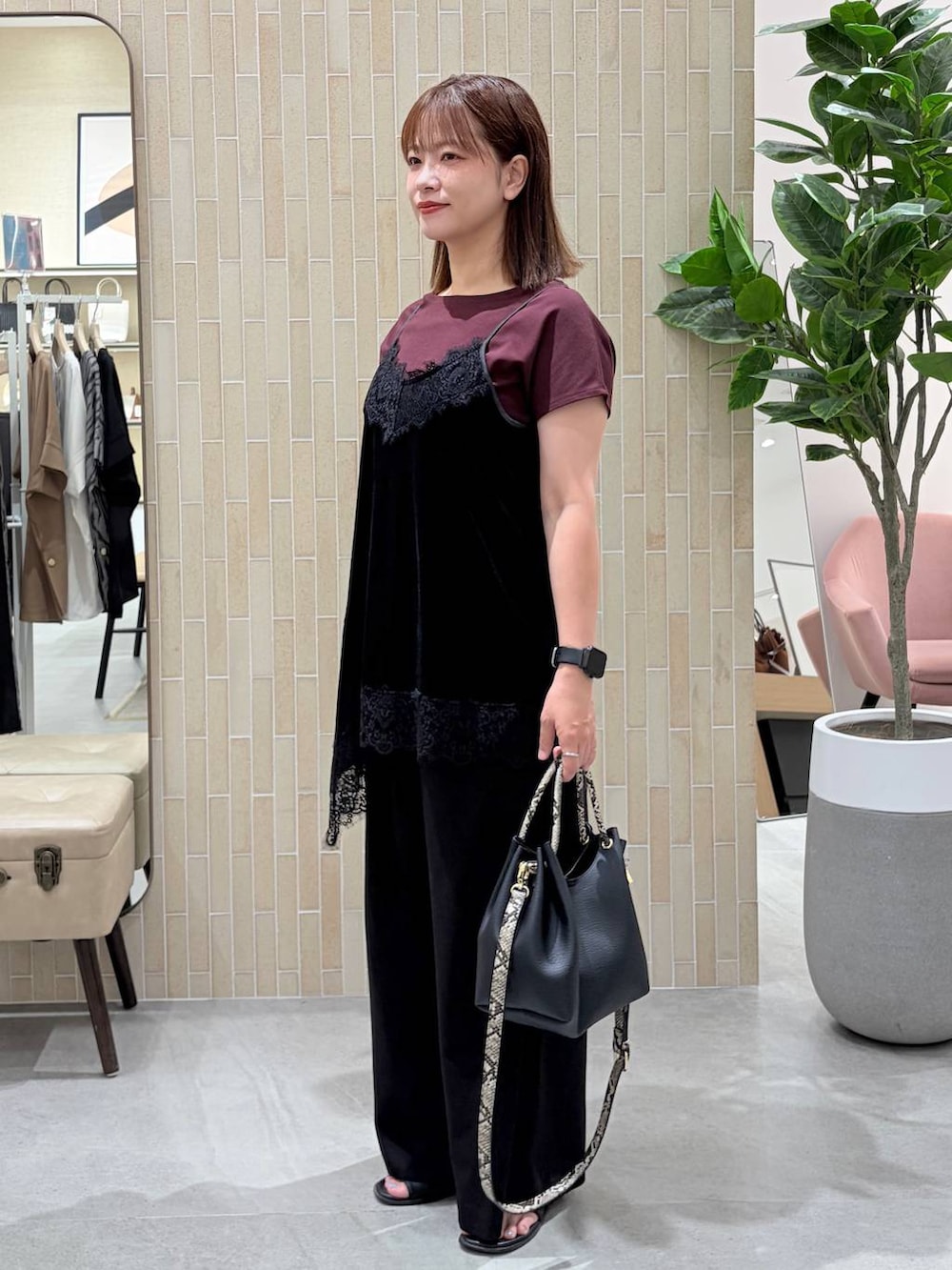 レッド系のTシャツ/カットソー、ブラック系のキャミソール、ブラック系のハンドバッグを着用したレディースの夏コーディネートの3枚目の写真