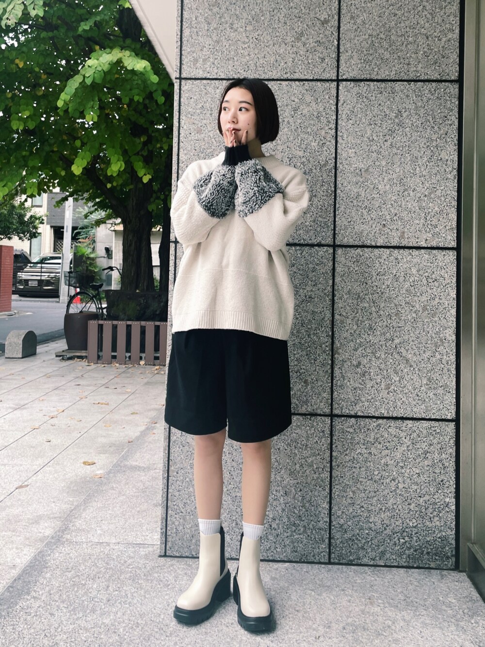 ブラック系のその他パンツ、ベージュ系のニット/セーター、ホワイト系のブーツを着用したレディースの秋コーディネートの2枚目の写真