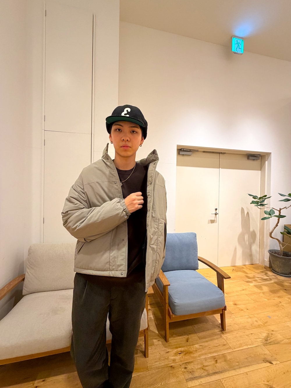 ベージュ系のダウンジャケット/コート、ブラウン系のニット/セーター、グリーン系のその他パンツを着用したメンズの冬コーディネートの4枚目の写真