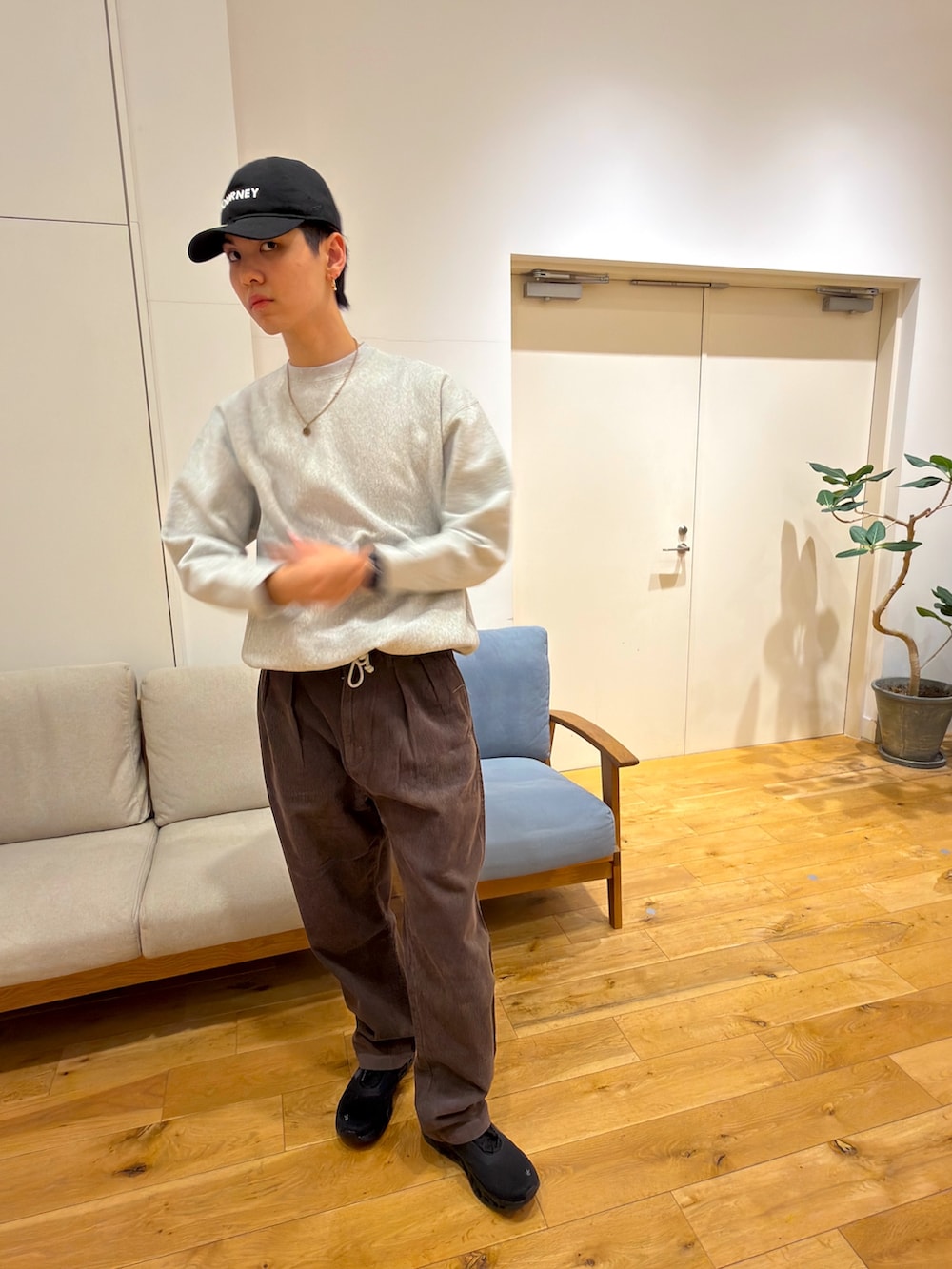 ホワイト系のスウェット、ブラウン系のその他パンツ、ブラック系のスニーカーを着用したメンズの冬コーディネートの2枚目の写真