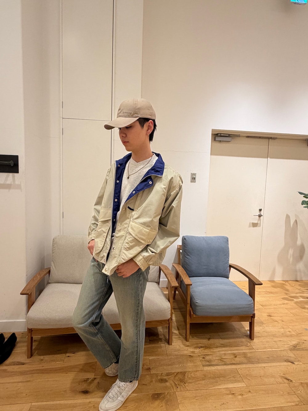 ブラック系のナイロンジャケット、ブラック系のデニムパンツ、ホワイト系のスニーカーを着用したメンズの冬コーディネートの4枚目の写真