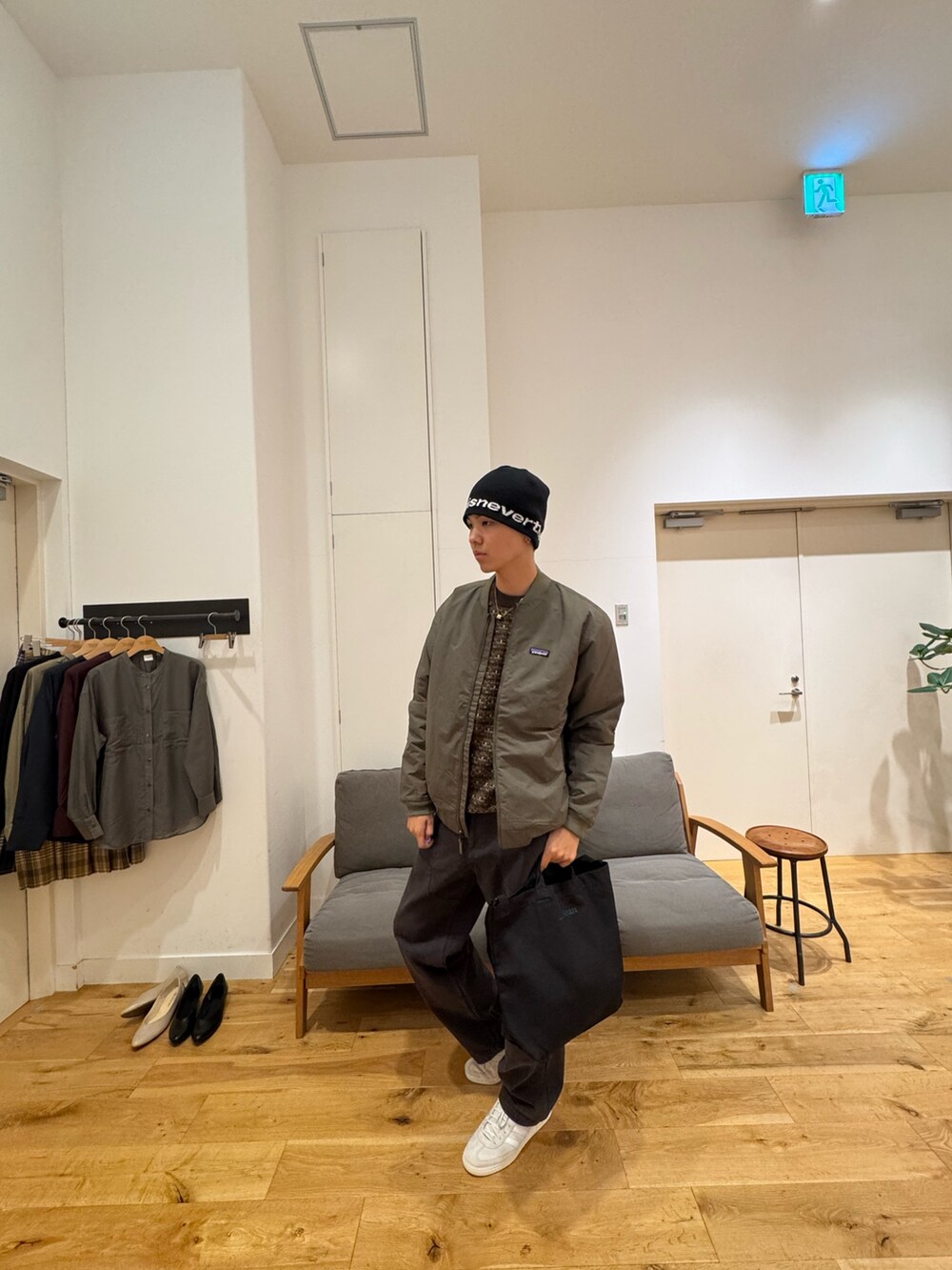 グリーン系のジャケット/アウター、ブラック系のパンツ、ホワイト系のスニーカーを着用したメンズの秋コーディネートの5枚目の写真