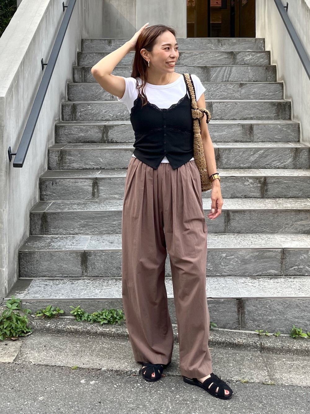 ブラウン系のその他パンツ、ブラック系のサンダル、ブラック系のTシャツ/カットソーを着用したレディースの夏コーディネートの2枚目の写真