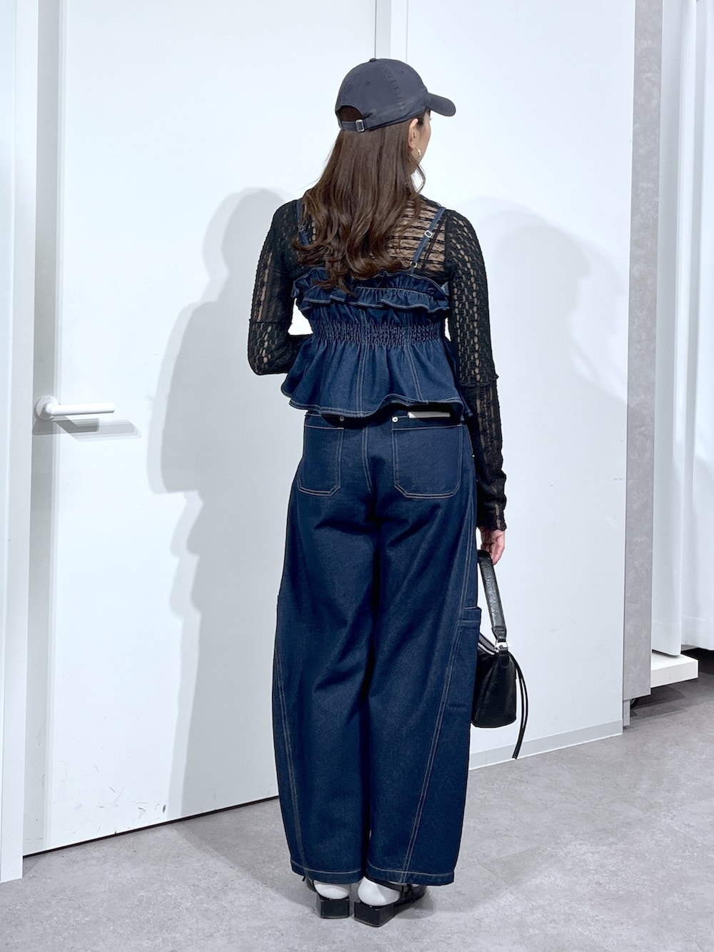 ブラック系のTシャツ/カットソー、ブルー系のシャツ/ブラウス、ブラック系のバッグを着用したレディースの春コーディネートの5枚目の写真