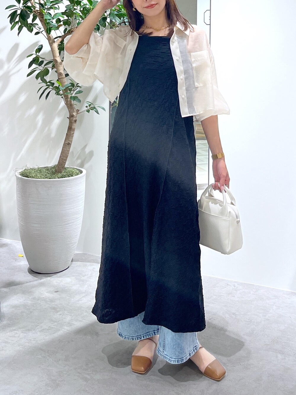 ホワイト系のシャツ/ブラウス、ブラック系のワンピース、ホワイト系のトートバッグを着用したレディースの春コーディネートの8枚目の写真