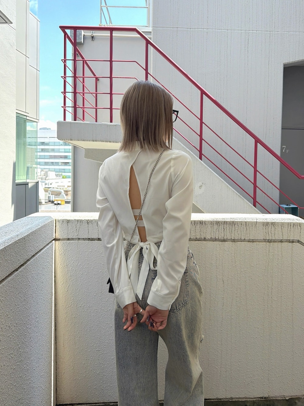 ホワイト系のシャツ/ブラウス、ブルー系のつなぎ/オールインワン、ホワイト系のサンダルを着用したレディースの春コーディネートの3枚目の写真