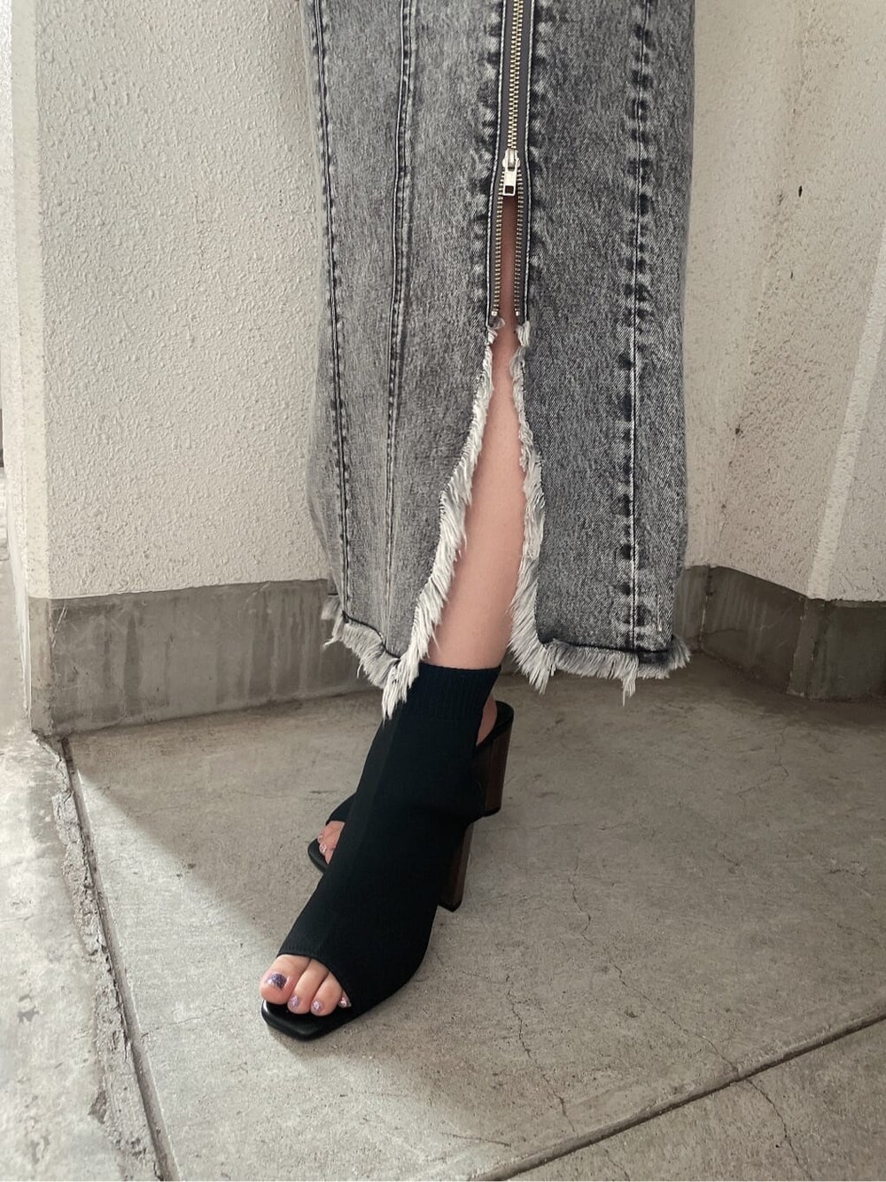 ブラック系のブーツ、ブラック系のデニムスカート、ブラック系のTシャツ/カットソーを着用したレディースの夏コーディネートの7枚目の写真