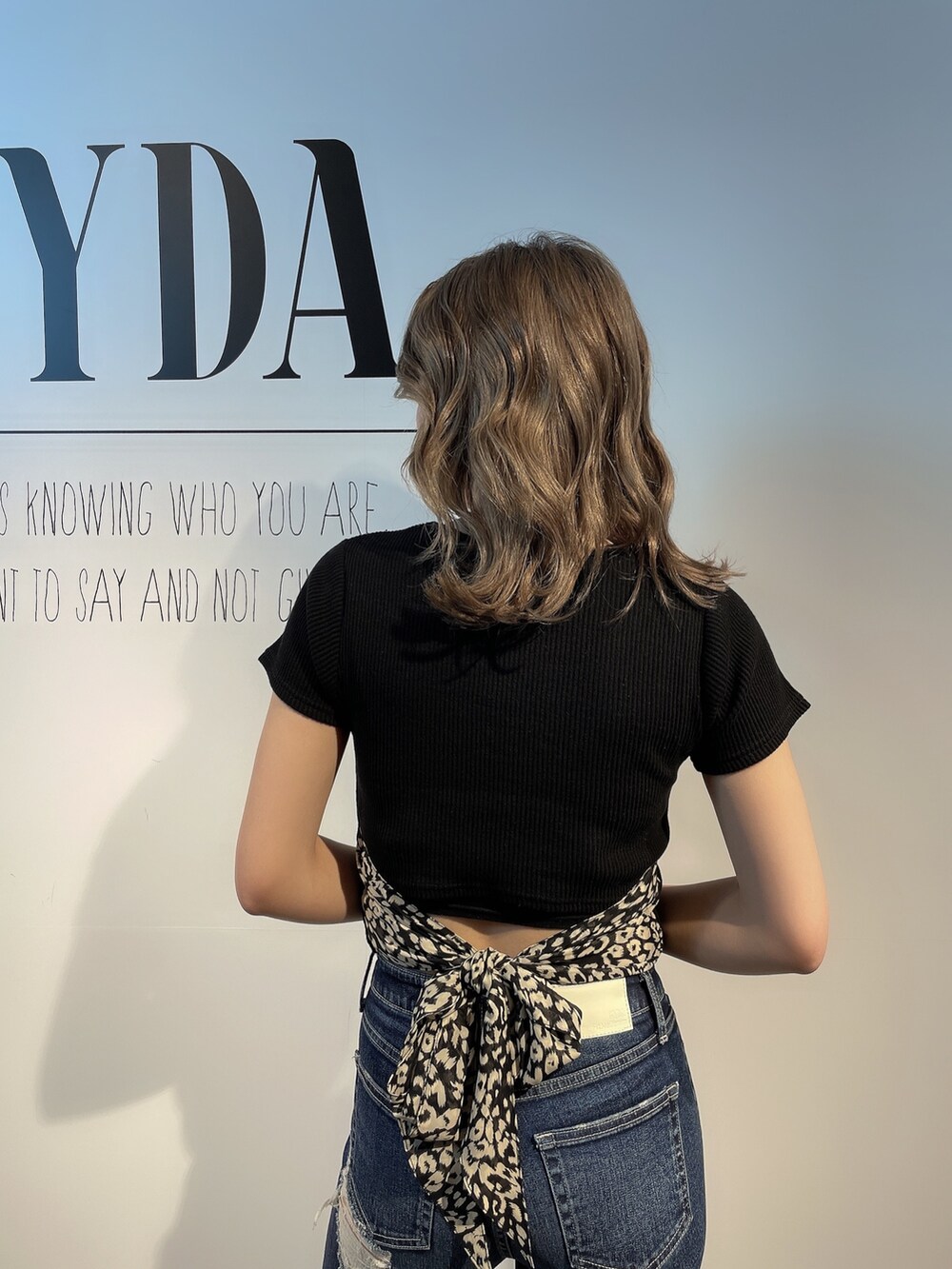 ホワイト系のTシャツ/カットソー、ブルー系のデニムパンツ、ブラック系のパンプスを着用したレディースの春コーディネートの3枚目の写真