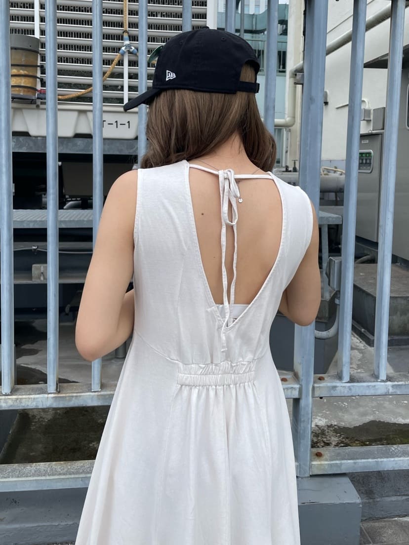 ホワイト系のワンピース、ブラック系のキャップを着用したレディースの春コーディネートの5枚目の写真