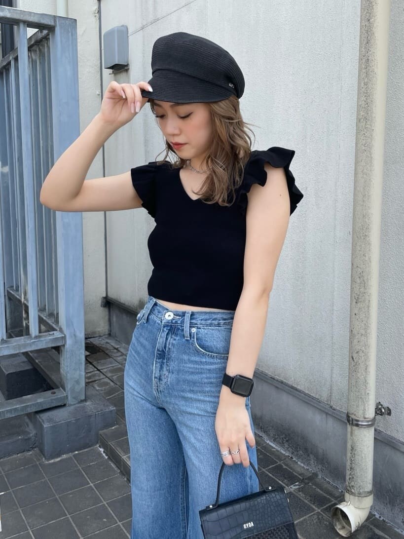 ブラック系のパンプス、ブラック系のハンドバッグ、ブラック系のニット/セーターを着用したレディースの春コーディネートの4枚目の写真