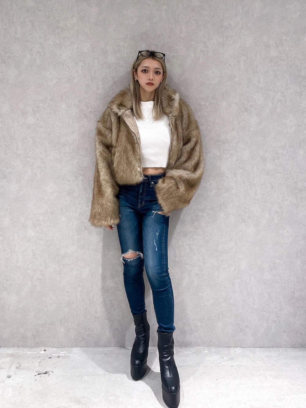 ベージュ系のその他アウター、ホワイト系のニット/セーター、ブルー系のデニムパンツを着用したレディースの冬コーディネートの3枚目の写真