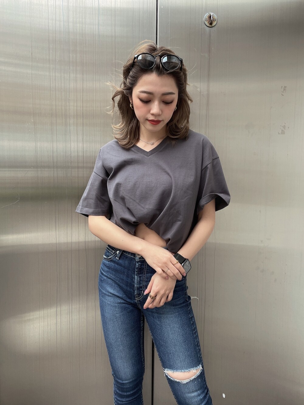 グレー系のTシャツ/カットソー、ブルー系のデニムパンツ、ブラック系のパンプスを着用したレディースの春コーディネートの5枚目の写真