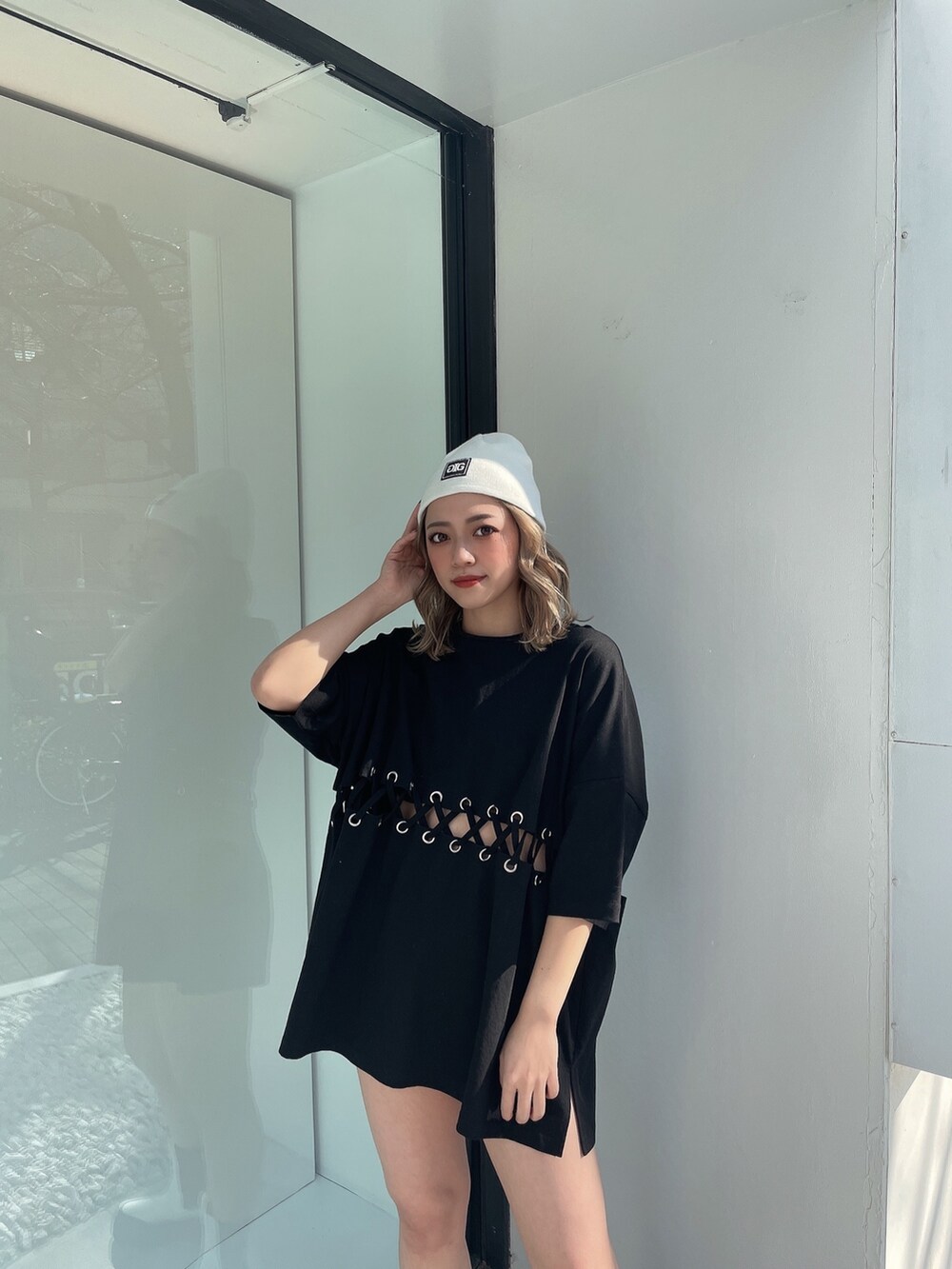 ブラック系のTシャツ/カットソー、ホワイト系のブーツ、ホワイト系のニットキャップ/ビーニーを着用したレディースの冬コーディネートの4枚目の写真