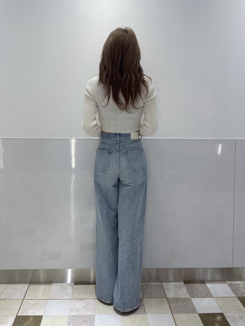 ホワイト系のカーディガン/ボレロ、ブルー系のデニムパンツ、ホワイト系のパンプスを着用したレディースの冬コーディネートの3枚目の写真