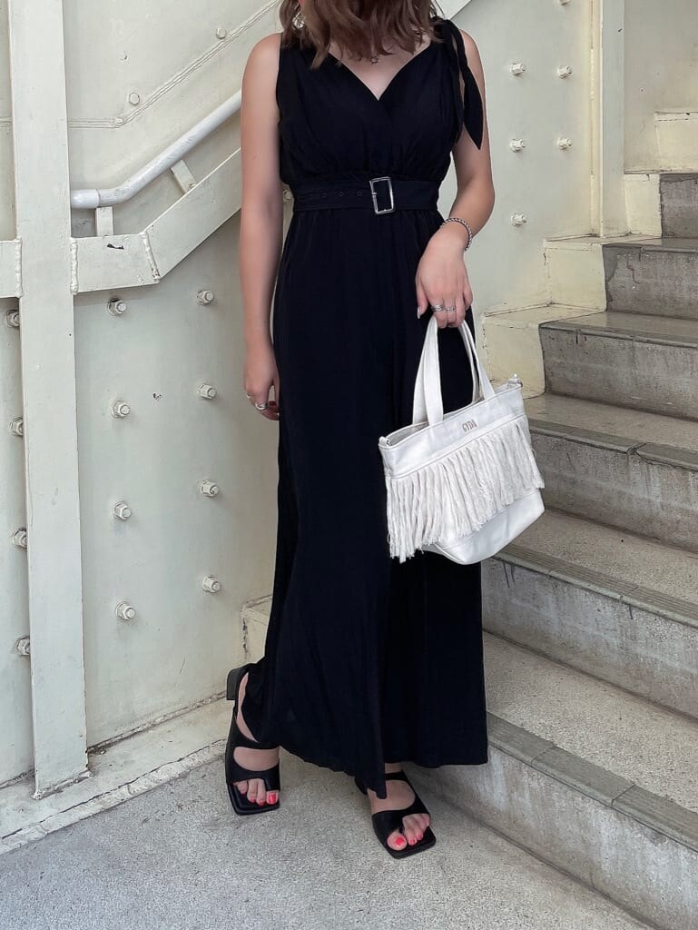 ブラック系のつなぎ/オールインワン、ブラック系のサンダル、ホワイト系のハンドバッグを着用したレディースの夏コーディネートの2枚目の写真