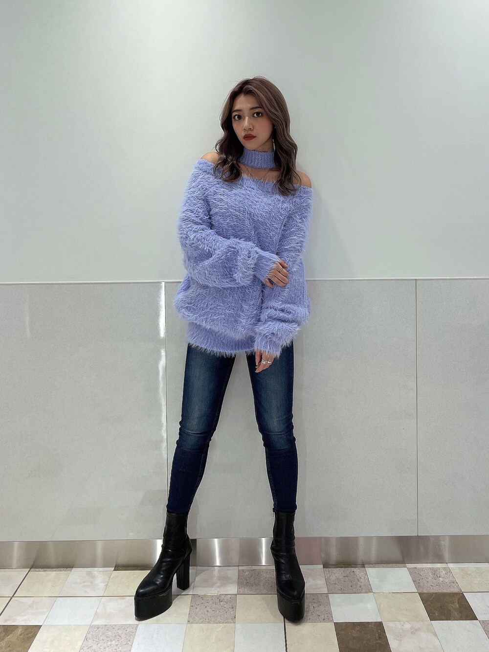 パープル系のニット/セーター、ブルー系のデニムパンツ、ブラック系のブーツを着用したレディースの秋コーディネートの3枚目の写真