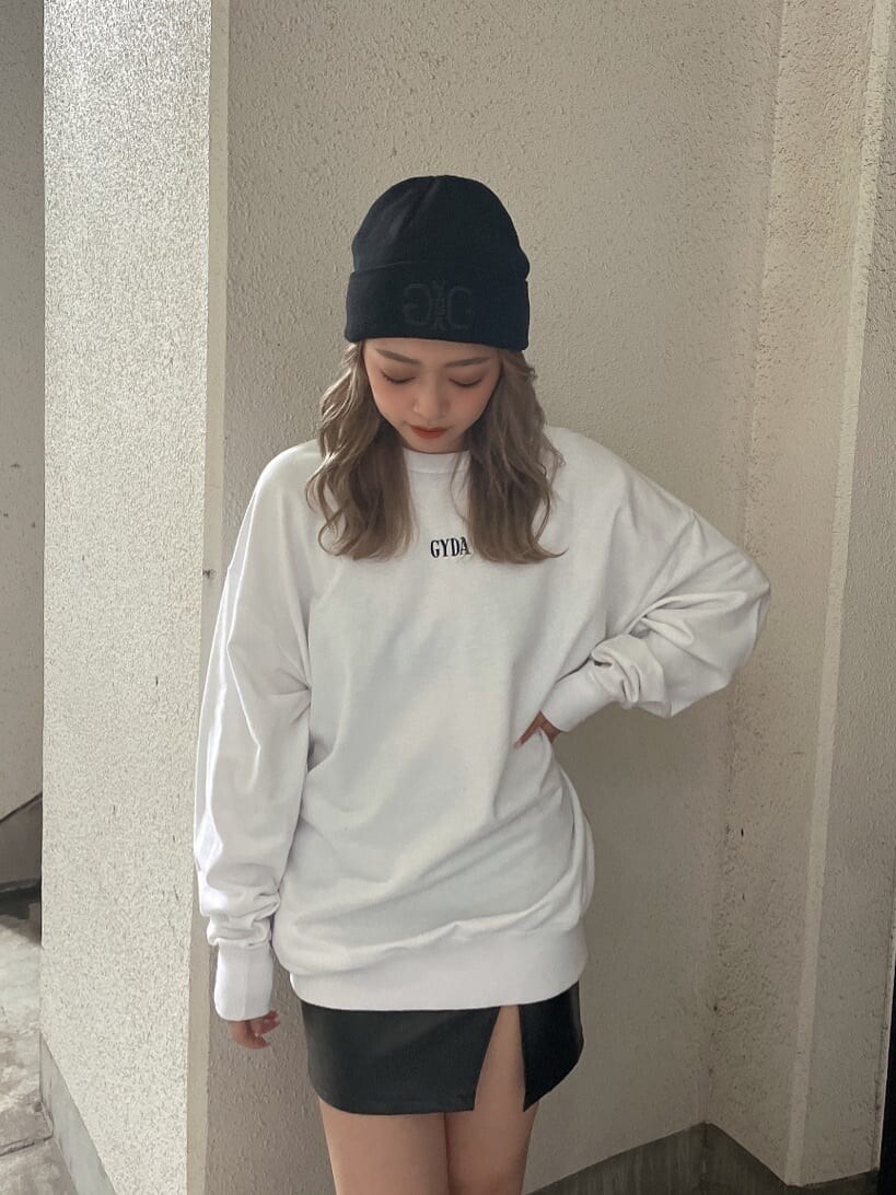 ブラック系のブーツ、ブラック系のスカート、ホワイト系のTシャツ/カットソーを着用したレディースの秋コーディネートの3枚目の写真