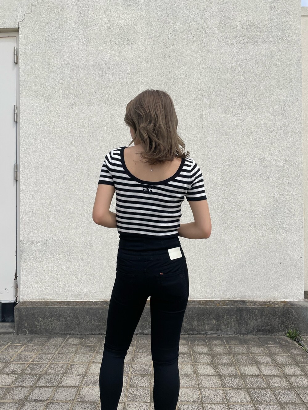ブラック系のデニムパンツ、その他のニット/セーター、ブラック系のパンプスを着用したレディースの春コーディネートの4枚目の写真