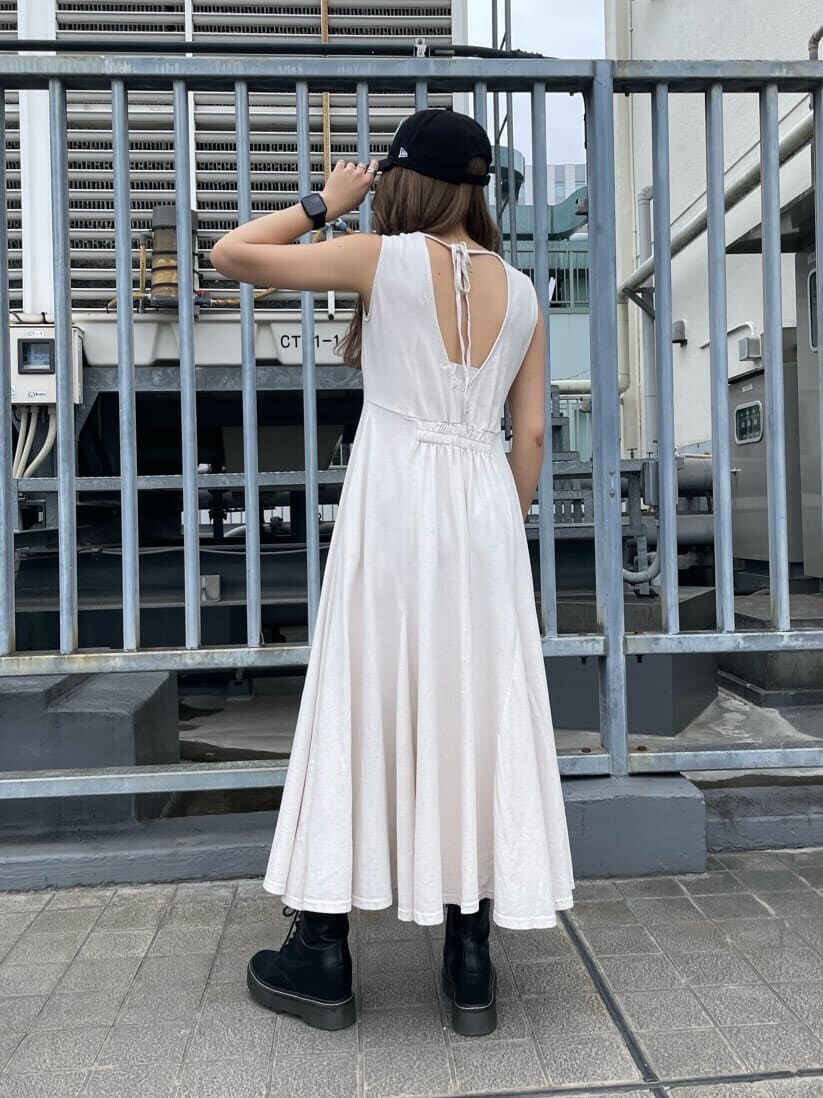 ホワイト系のワンピース、ブラック系のキャップを着用したレディースの春コーディネートの3枚目の写真