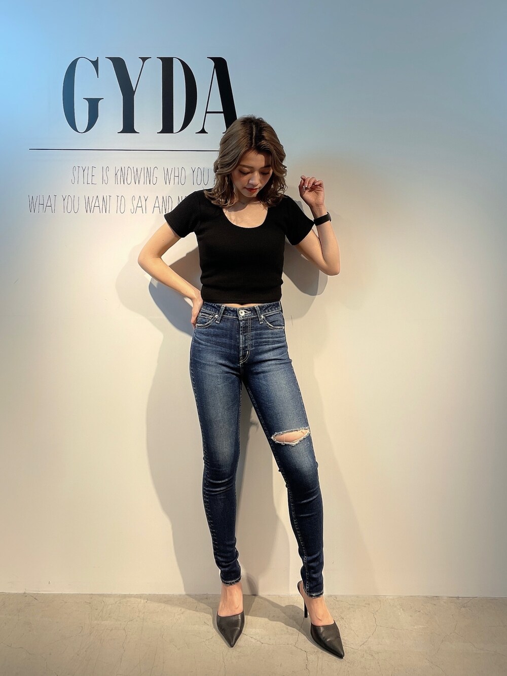 ホワイト系のTシャツ/カットソー、ブルー系のデニムパンツ、ブラック系のパンプスを着用したレディースの春コーディネートの2枚目の写真