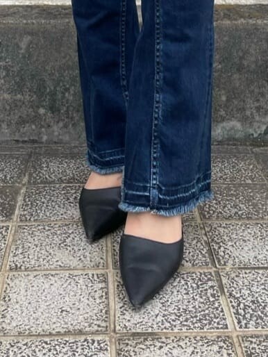 ブラック系のパンプス、イエロー系のスウェット、ブルー系のデニムパンツを着用したレディースの夏コーディネートの6枚目の写真