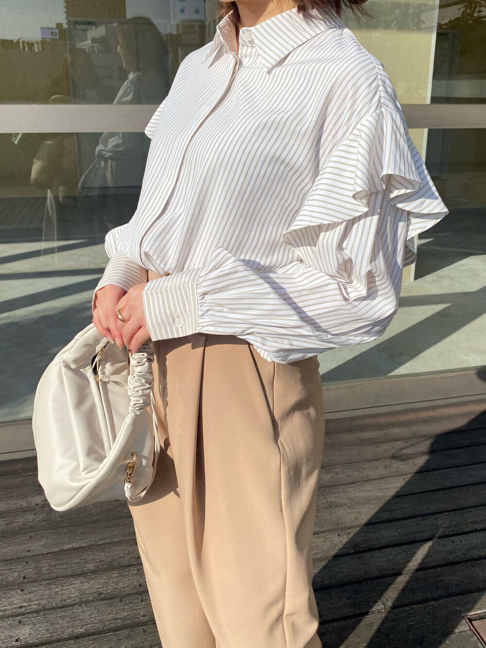 ベージュ系のその他シューズ、ベージュ系のシャツ/ブラウス、ホワイト系のその他パンツを着用したレディースの冬コーディネートの3枚目の写真