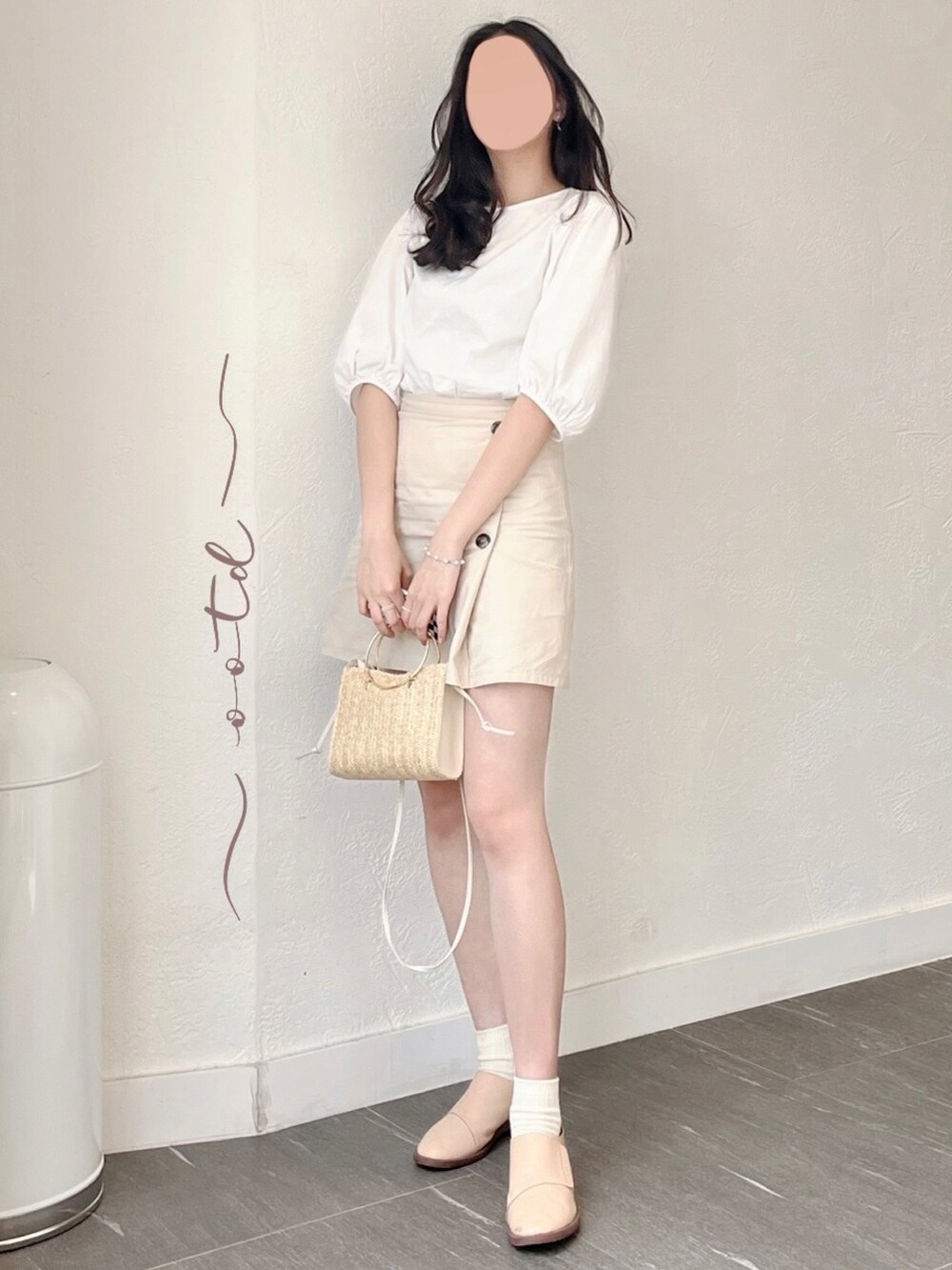 ベージュ系のスカート、ホワイト系のトップス、ベージュ系のレッグウェアを着用したレディースの春コーディネートの2枚目の写真