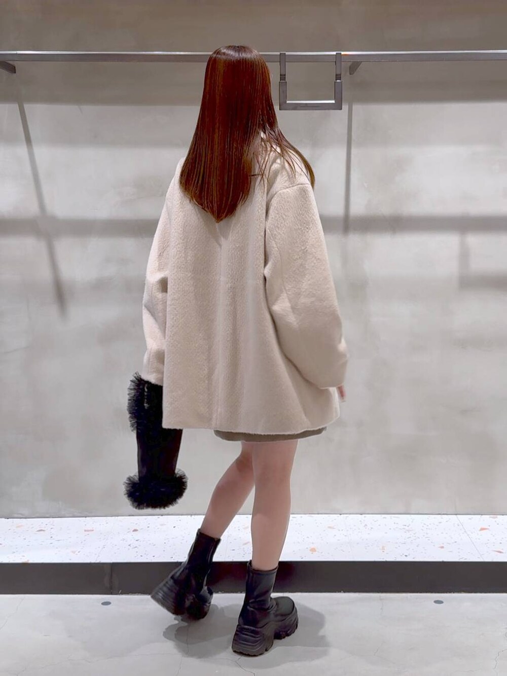 ブラック系のブーツ、ブラック系のトートバッグ、ベージュ系のその他アウターを着用したレディースの冬コーディネートの8枚目の写真