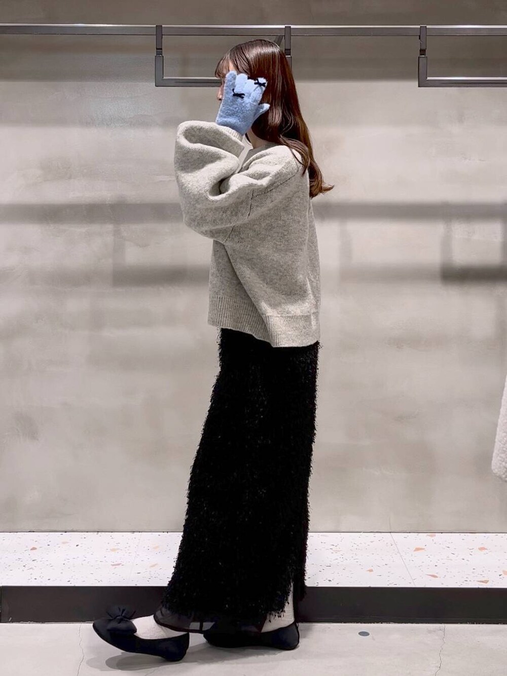 ブラック系のバレエシューズ、グレー系のニット/セーター、ブラック系のスカートを着用したレディースの秋コーディネートの4枚目の写真