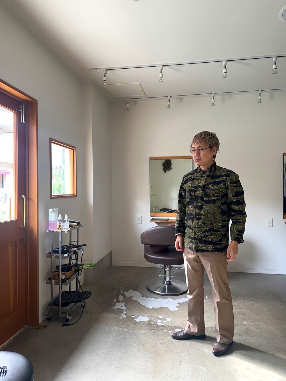 ベージュ系のスラックス、グリーン系のシャツ/ブラウスを着用したメンズの秋コーディネートの3枚目の写真