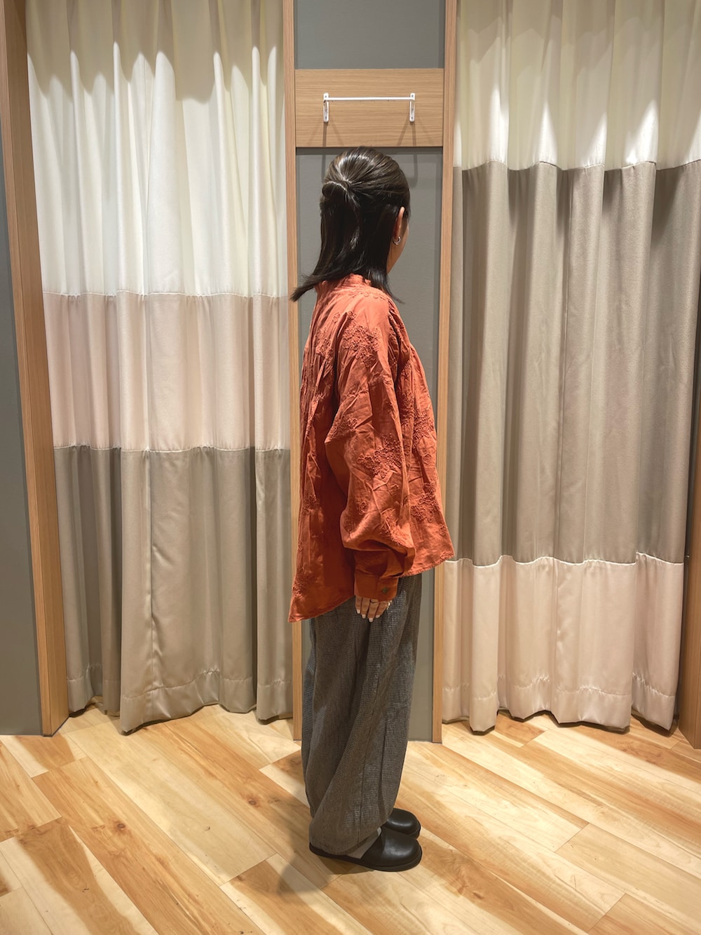 ブラック系のドレスシューズ、オレンジ系のシャツ/ブラウス、グレー系のその他パンツを着用したレディースの秋コーディネートの2枚目の写真