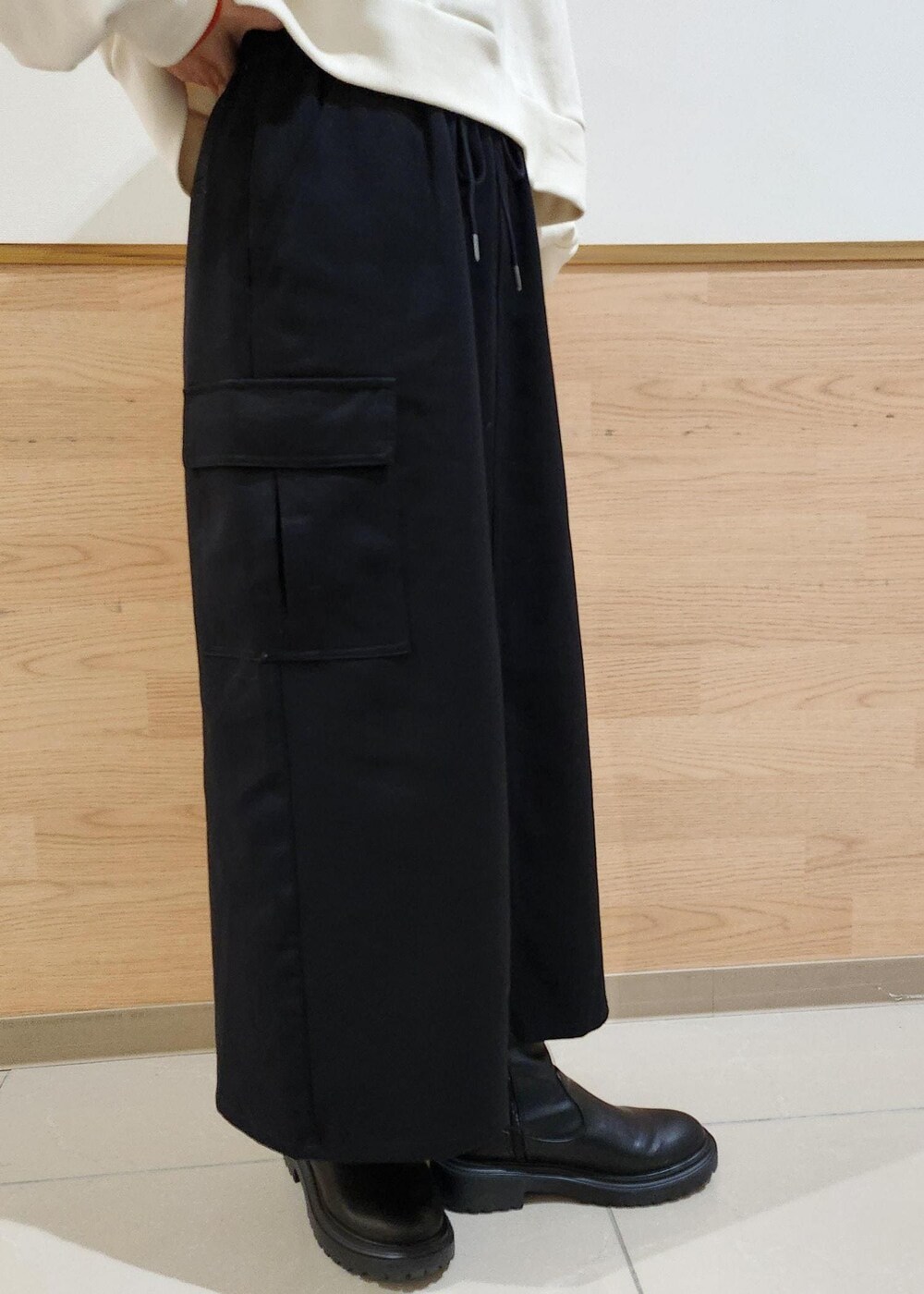 レッド系のニット/セーター、ホワイト系のダウンジャケット/コート、ブラック系のトートバッグを着用したレディースの冬コーディネートの6枚目の写真