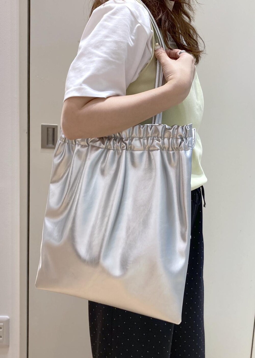 ベージュ系のタンクトップ、ホワイト系のTシャツ/カットソー、ブラック系のサンダルを着用したレディースの夏コーディネートの7枚目の写真