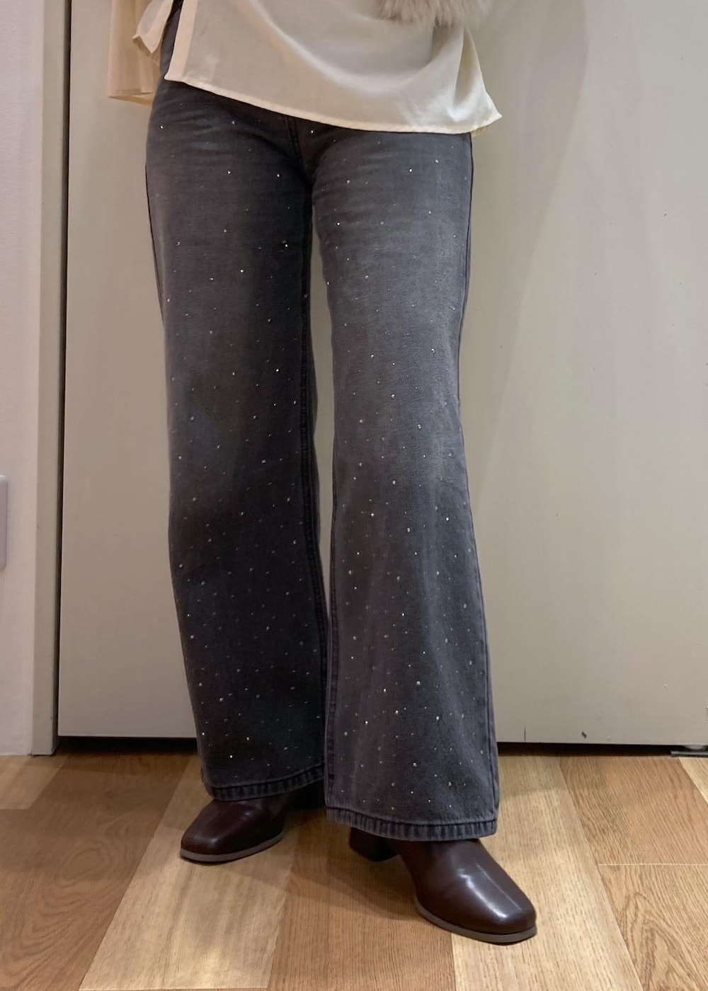 ベージュ系のシャツ/ブラウス、ベージュ系のベスト、ブラック系のデニムパンツを着用したレディースの秋コーディネートの5枚目の写真