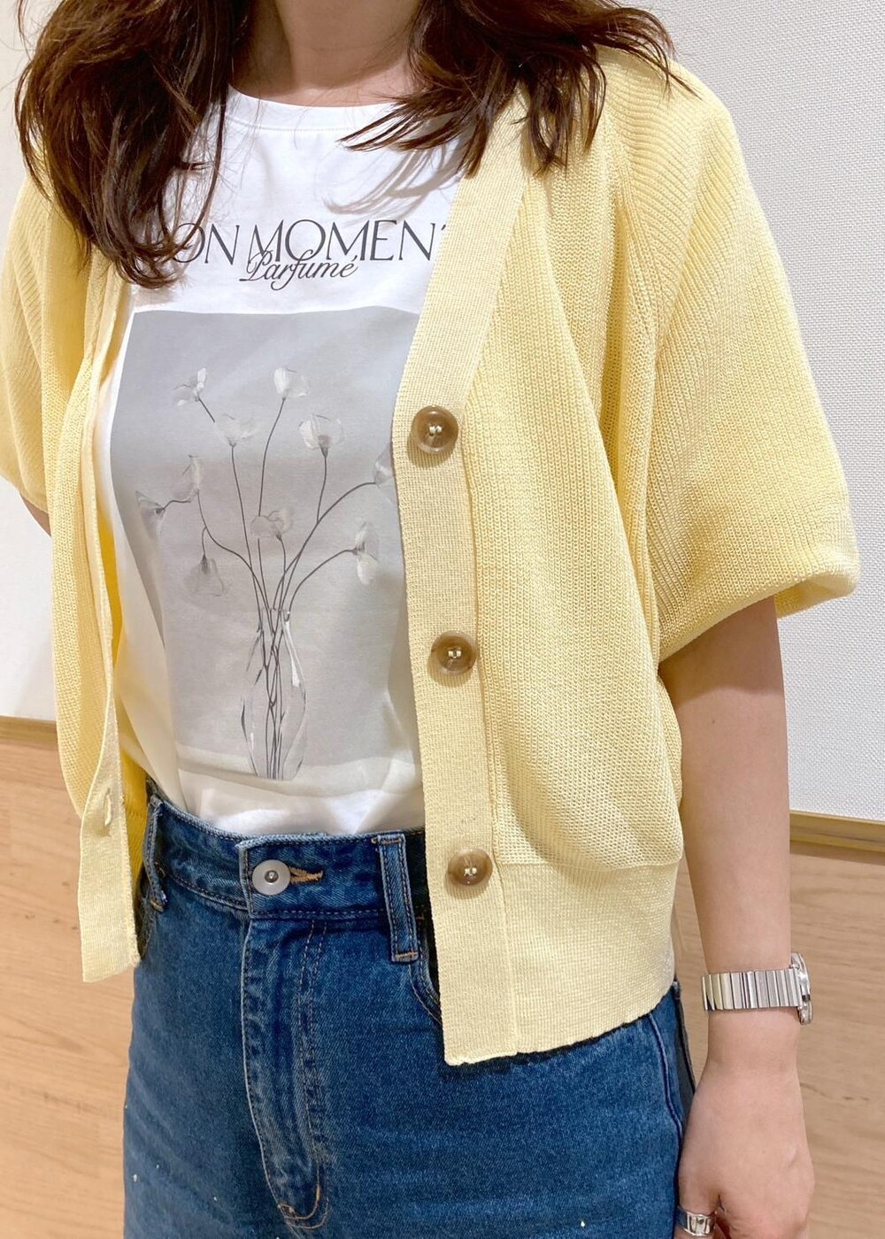 ブルー系のデニムパンツ、ブラック系のトートバッグ、ホワイト系のTシャツ/カットソーを着用したレディースの春コーディネートの5枚目の写真