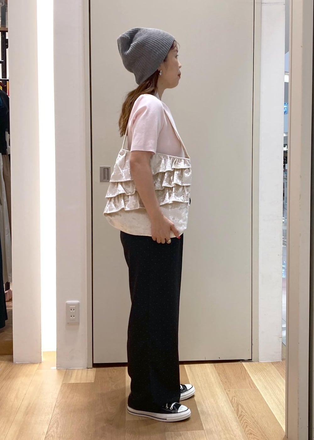 ピンク系のニット/セーター、ブラック系のその他パンツ、ホワイト系のトートバッグを着用したレディースの夏コーディネートの2枚目の写真