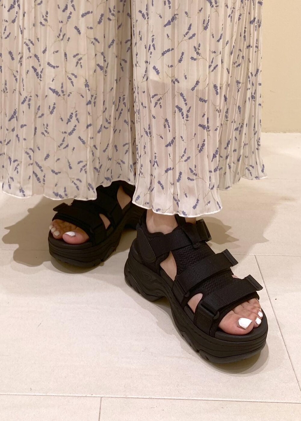 ホワイト系のニット/セーター、ホワイト系のその他パンツ、ブラック系のバックパック/リュックを着用したレディースの夏コーディネートの8枚目の写真