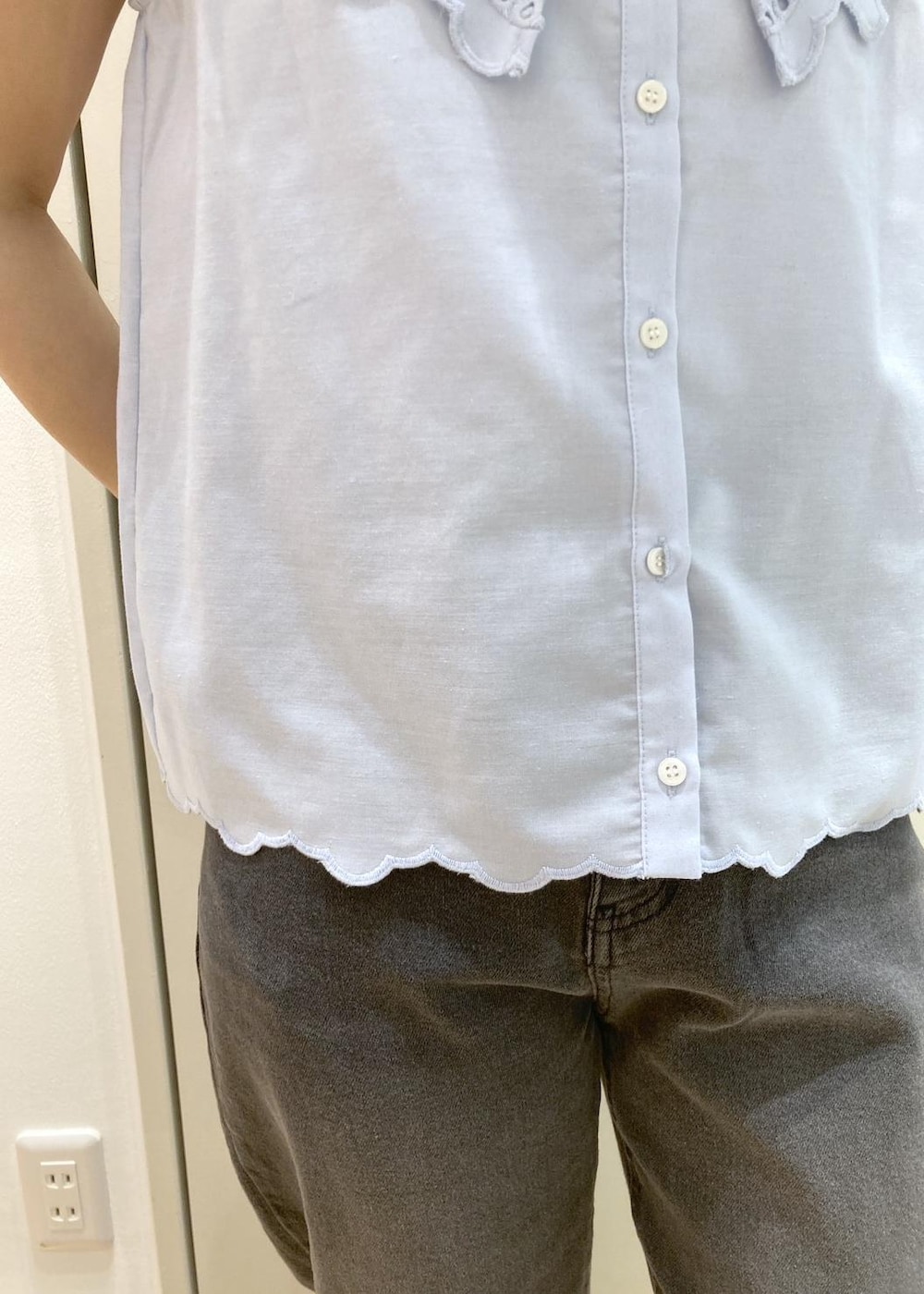 ブラック系のデニムパンツ、ブラック系のショルダーバッグ、ブラック系のサンダルを着用したレディースの夏コーディネートの5枚目の写真