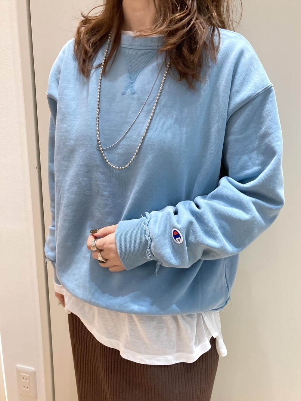 ホワイト系のTシャツ/カットソー、ブラック系のブーツ、ブラウン系のショルダーバッグを着用したレディースの冬コーディネートの4枚目の写真