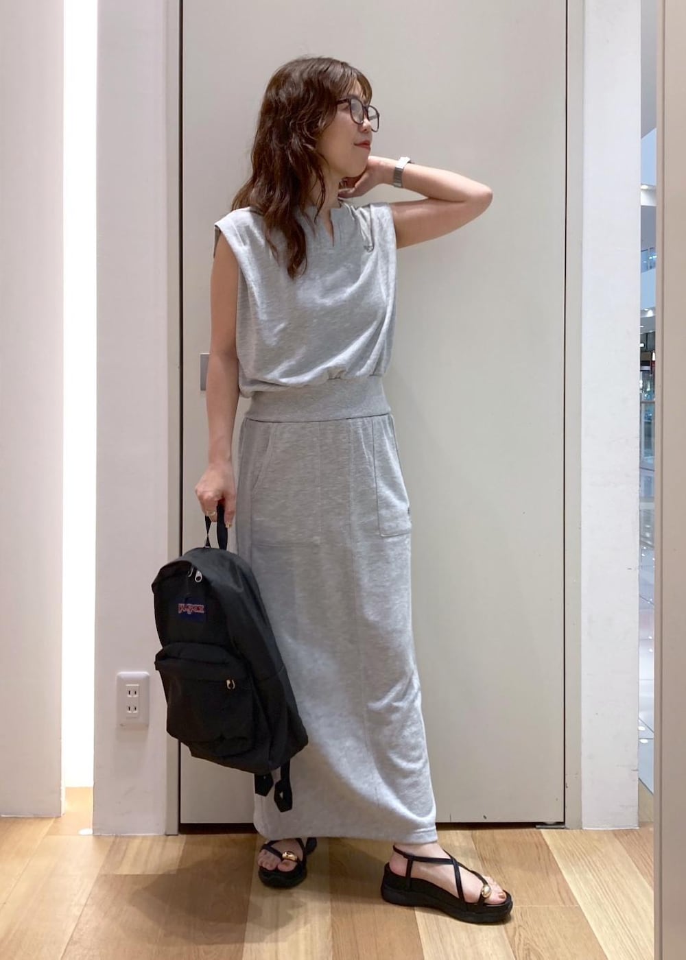 ブラック系のサンダル、グレー系のスカート、グレー系のTシャツ/カットソーを着用したレディースの夏コーディネートの2枚目の写真