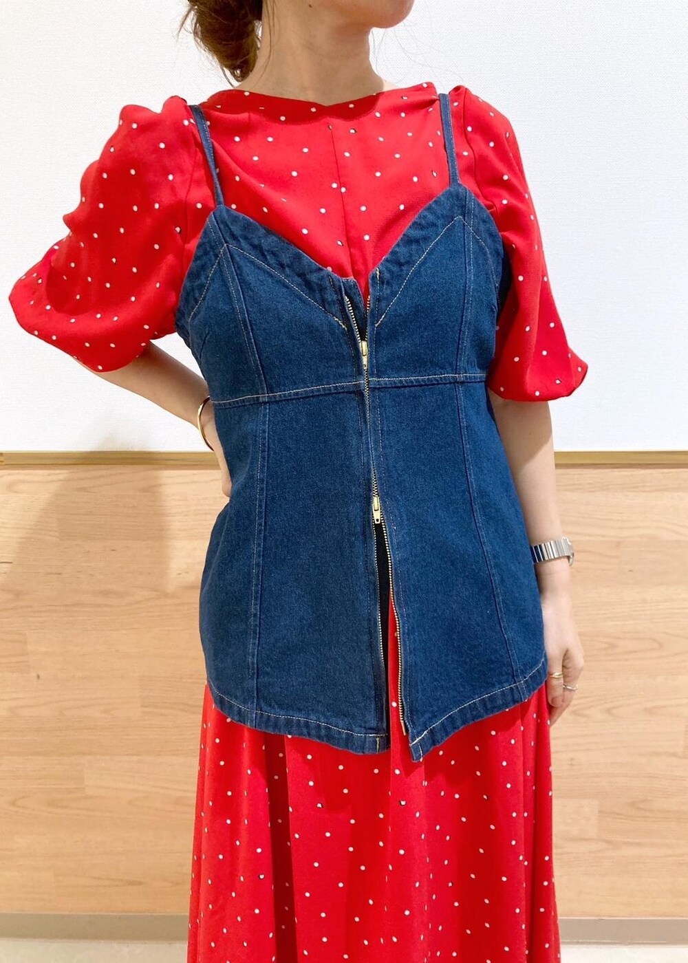 ブラック系のサンダル、シルバー系のショルダーバッグ、ブルー系のベストを着用したレディースの春コーディネートの3枚目の写真