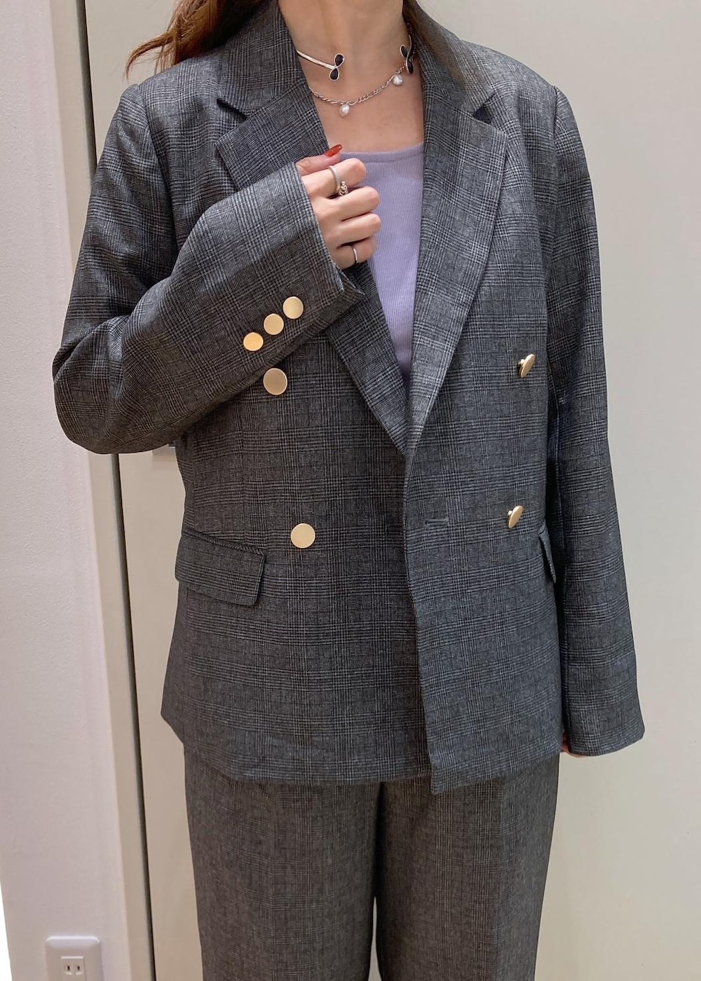 イエロー系のトートバッグ、パープル系のタンクトップ、グレー系のテーラードジャケットを着用したレディースの秋コーディネートの4枚目の写真